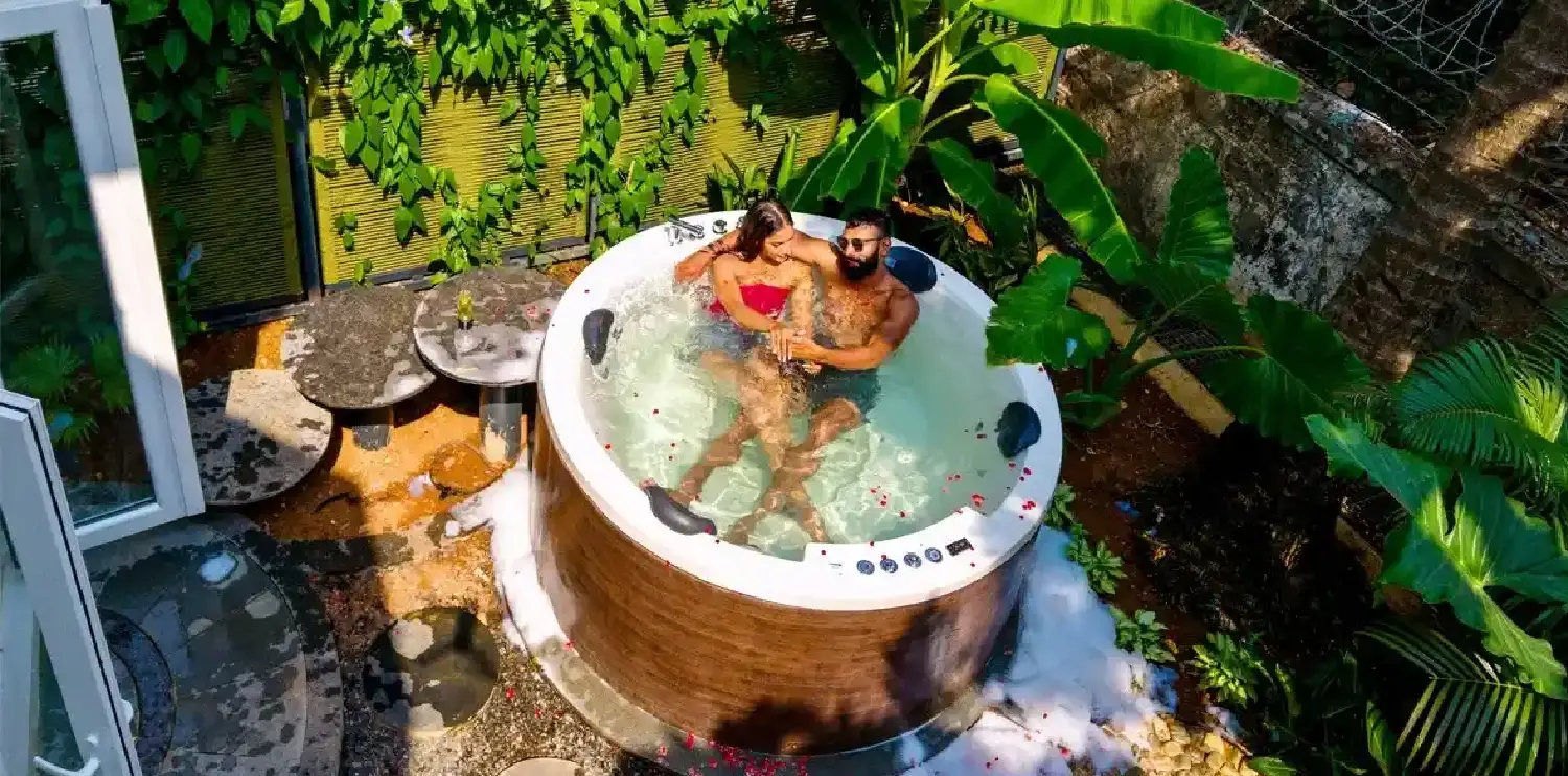 Where to Stay in South Goa for Couples | Benaulim Beach Guide Couple enjoying a private Jacuzzi at Orchid Passaros in Benaulim, South Goa