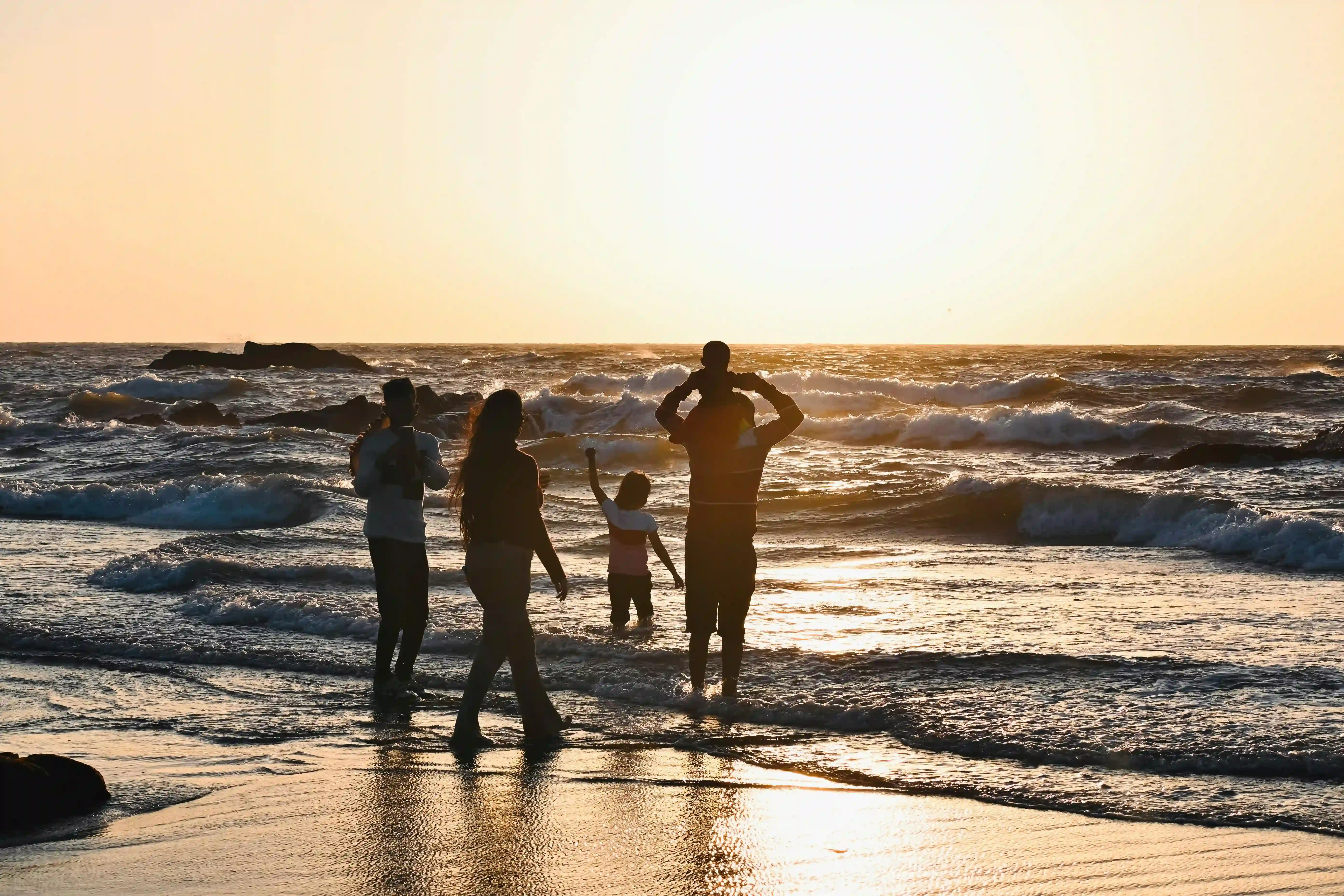 Travelers relaxing on South Goa beach near luxury hotel in Goa by the sea